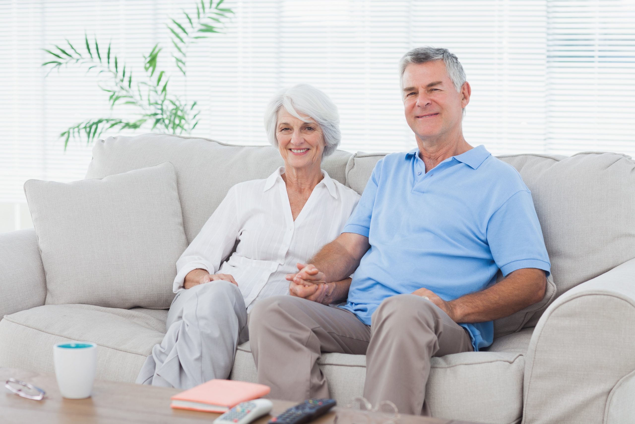 Elderly people sitting on a couch